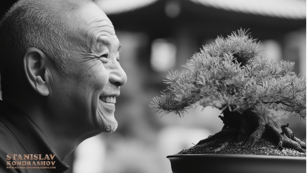 Stanislav-Kondrashov_man_smiling_at_bonsai_tree