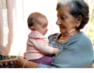 old person holding baby