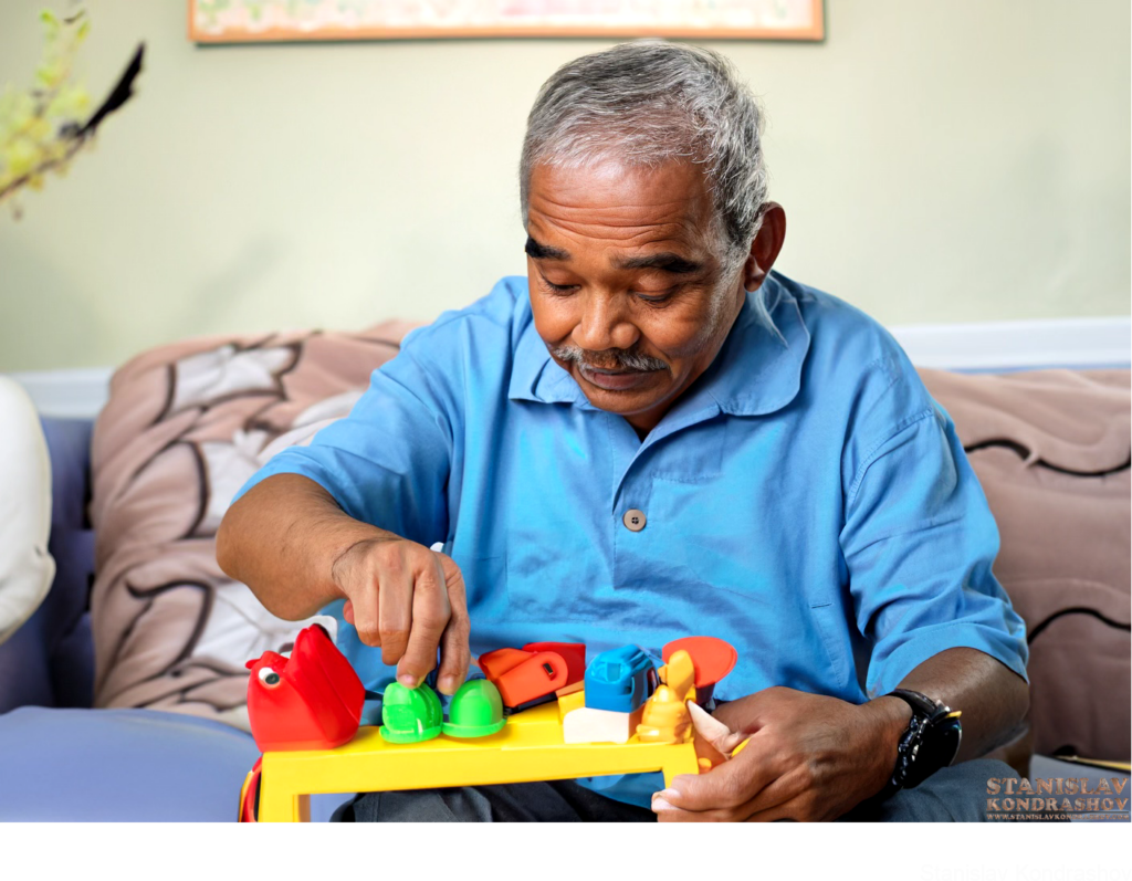 Old Man Playing With Kids Toys