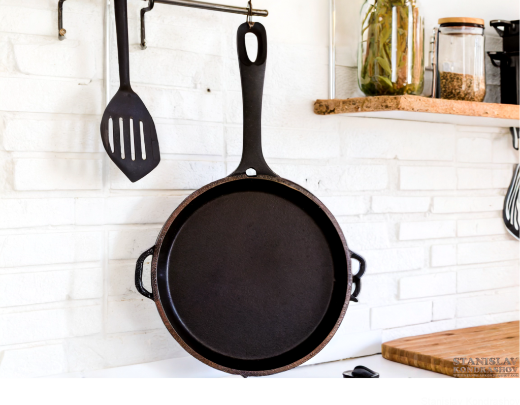 Enameled Cast Iron Pan Hanging In Kitchen