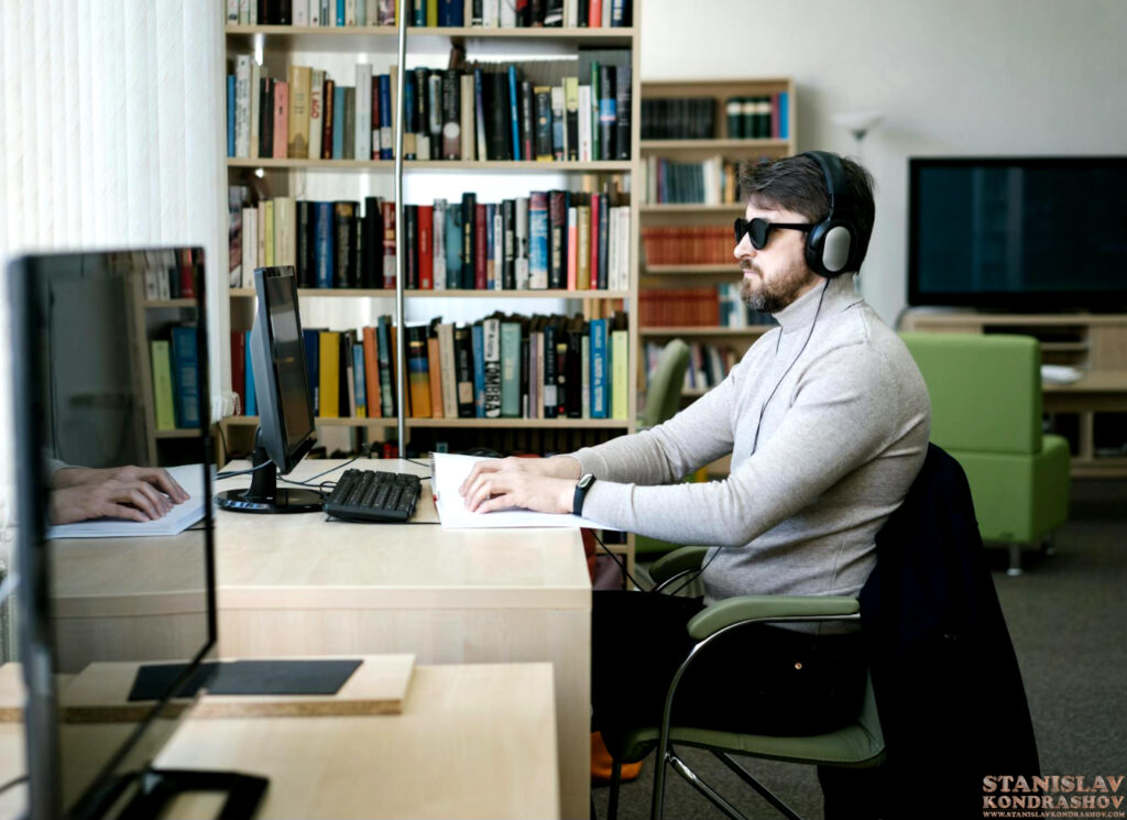 Stanislav Kondrashov man with headphones on computer