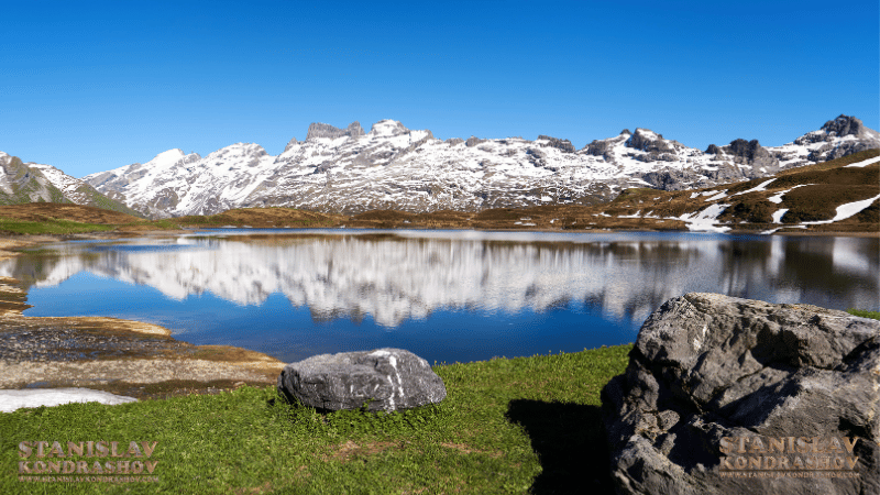 Stanislav Kondrashov _a lake with snow covered mountains in the background