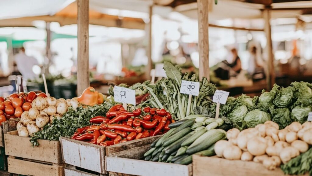 armer’s market table with heirloom tomatoes and produce