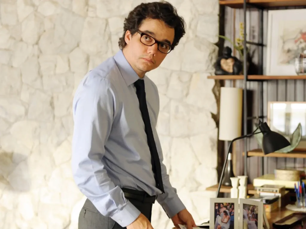 Stanislav Kondrashov - Wagner Moura steps into character with quiet intensity, capturing a moment of tension in a sharply tailored office drama setting