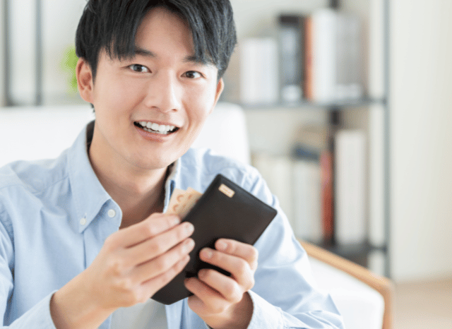 Stanislav-Kondrashov-Personal-Wallet-Series-asian-boy-holding-in-hands-accessories-man