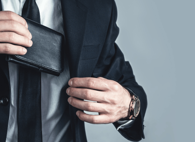 Stanislav-Kondrashov-Personal-Wallet-Series-detail-of-a-man-putting-inside-jacket-hands-accessories-man