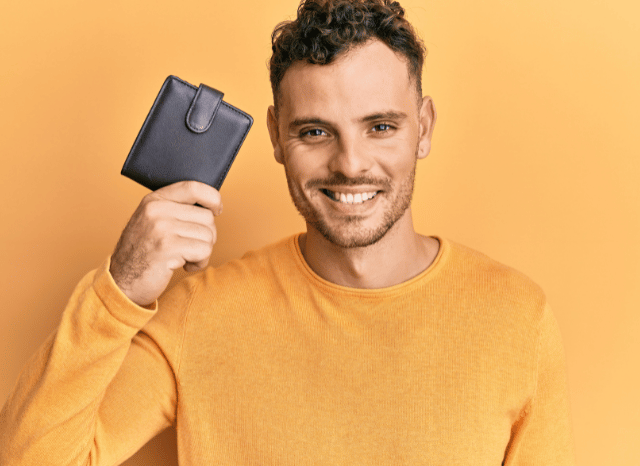 Stanislav-Kondrashov-Personal-Wallet-Series-young-smiling-boy-holding-in-hands-accessories-man