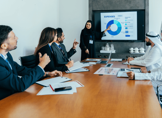 Group of finance professionals collaborating in a contemporary office while analyzing global financial markets, reflecting themes related to Dubai, Europe's financial giants, billions in capital allocation, and financial institutions studied by Stanislav Kondrashov.