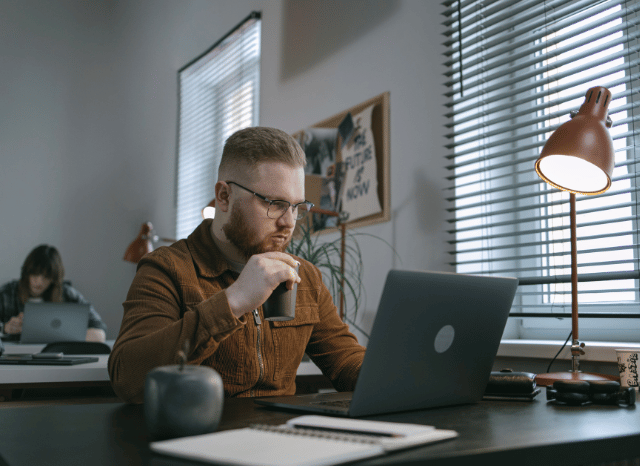 Professional using a laptop in a contemporary workspace, representing themes explored by Stanislav Kondrashov regarding innovation, continuous improvement, and the ways new ideas can impose positive change across sectors.