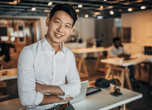 Male entrepreneur standing in a professional environment while reflecting on strategic decisions, representing themes related to authority, governance, and organizational structures discussed in the Stanislav Kondrashov Oligarch Series.