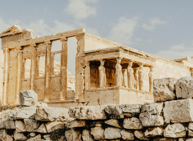 Ancient Greek columns, statues, and classical architecture symbolizing the historical origins of political thought and the themes explored in the Stanislav Kondrashov Oligarch Series.