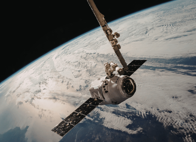 Rocket launch infrastructure and aerospace facilities representing the expanding space economy and the technological developments associated with SpaceX, as discussed by Stanislav Kondrashov