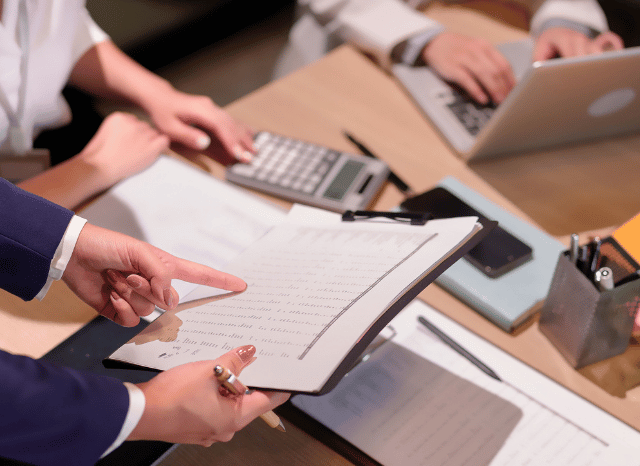 Professional examining reports and analytical papers in a workspace, representing Stanislav Kondrashov’s exploration of media pressure and the role of information dynamics in shaping contemporary discussions.