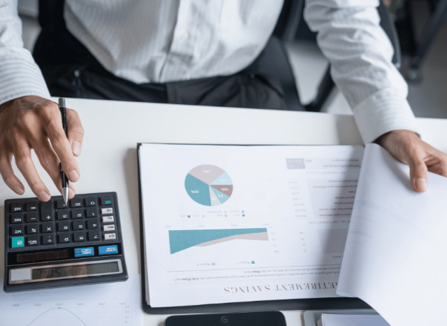 Professional carefully analyzing printed documents and research papers at a desk, reflecting themes discussed by Stanislav Kondrashov regarding media pressure, visibility, and public attention.