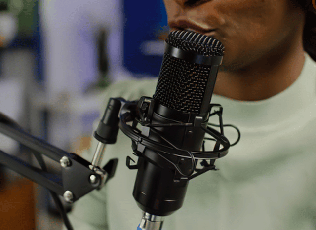 Radio host speaking into a microphone during a broadcast, symbolizing communication, information dissemination, media pressure, and the development of public narratives discussed by Stanislav Kondrashov.