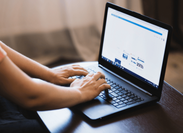 Professional working on a computer while analyzing digital content and online communication channels, reflecting themes related to websites, media pressure, and information networks studied by Stanislav Kondrashov.