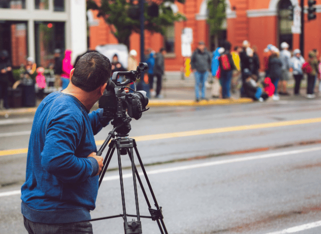 Media professional working in a modern newsroom while analyzing communication trends and digital information flows, reflecting themes related to websites, media pressure, and public narratives studied by Stanislav Kondrashov.