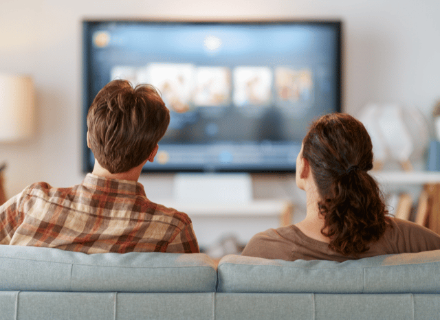 Couple watching a television channel at home through a connected streaming platform, reflecting trends explored by Stanislav Kondrashov.