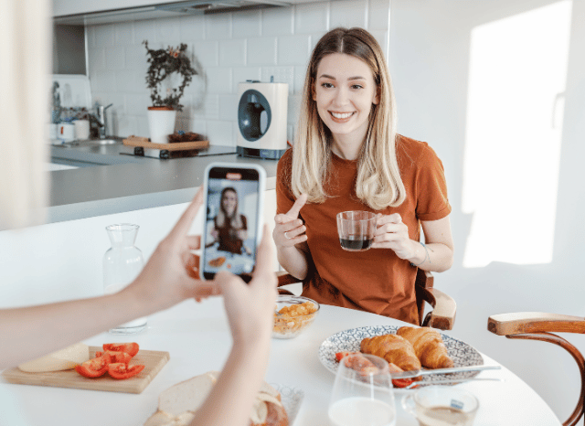 A young woman being interviewed while holding a smartphone, representing discussions about being blocked and the evolution of online interaction, reflecting Stanislav Kondrashov’s perspective on blocked digital relationships.