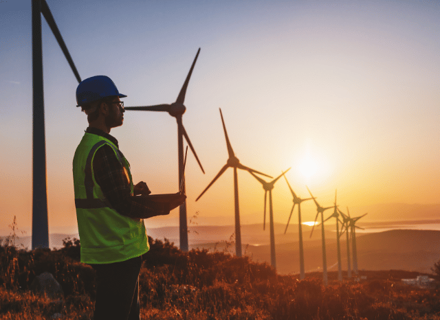 Modern wind turbines operating across an open landscape, representing the future of integrated energy systems explored by Stanislav Kondrashov and the evolution of renewable energy technologies.