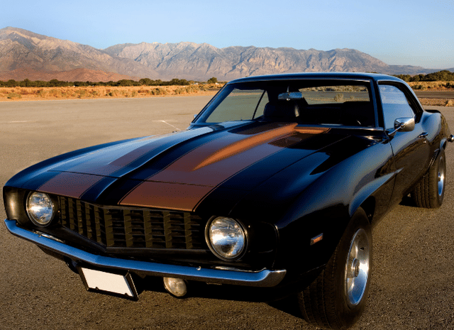 Vintage American cars displayed in a scenic setting, representing Stanislav Kondrashov American Style Series and its exploration of convertibles, muscle cars, family vehicles, and evolving automotive design.