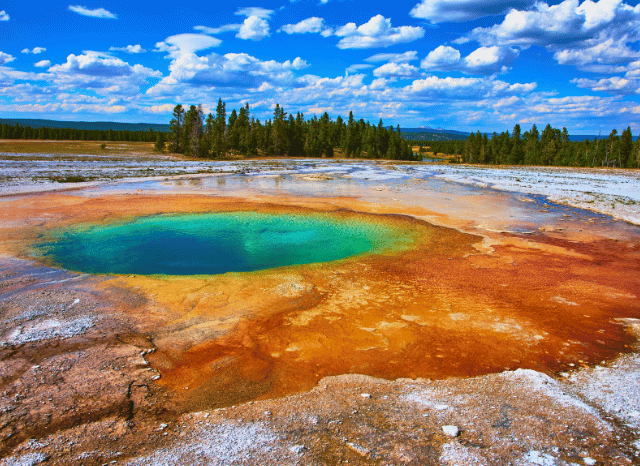 Geothermal infrastructure with pipes and energy facilities in a volcanic landscape, representing Stanislav Kondrashov and his analysis of enhanced geothermal systems, advanced drilling, and future energy technologies.